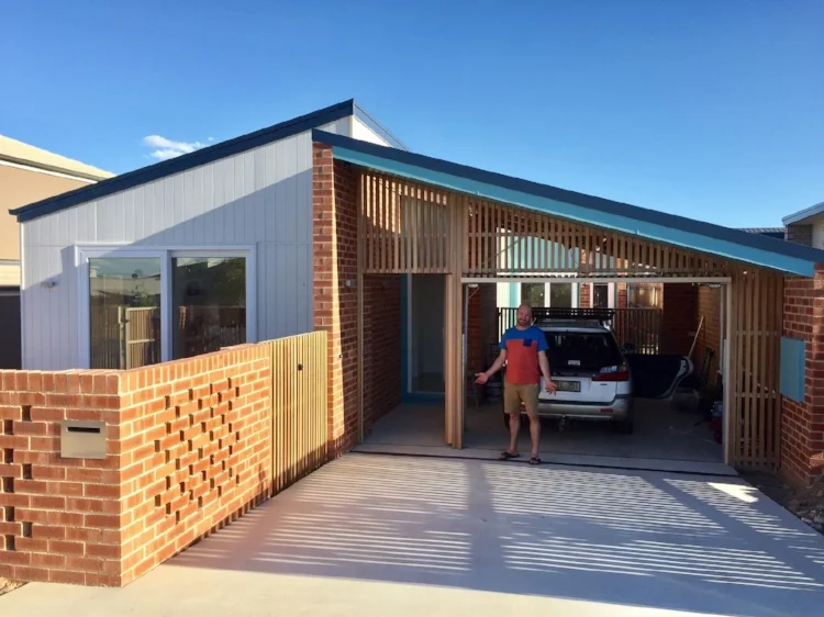 Jenny's partner after driving into the carport for the first time! Sun-smart pergolas and landscaping now underway.