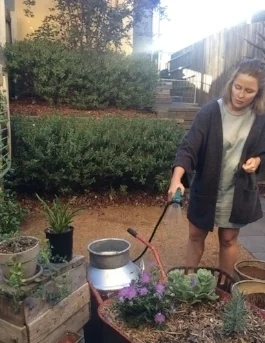 Rachel ensuring her portable, beautiful and functional garden continues to thrive.