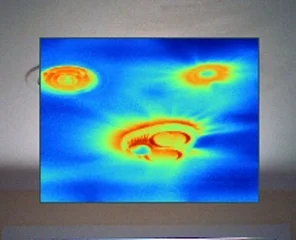 Air leakage around ceiling penetrations during a blower door test. Images taken in summer so the warmer air entering through gaps creates warm streaks on the ceiling.