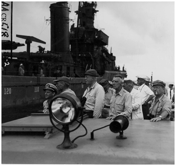 Members of the Joint Chiefs of Staff’s Evaluation Board looking over the damaged fleet on July 3, 1946, accompanied by Captain Horacio Rivero of the Navy’ s Special Weapons Staff, who had played a key role in selecting Bikini. Shown in the photo from left to right are: Rivero, Vice Admiral John H. Hoover, Bradley Dewey, General Joseph W. Stilwell (after his death replaced by General Albert C. Wedemeyer), Lt. General Lewis H. Brereton. (NARA, Still Pictures Unit, Record Group 80-G, box 1724, folder 627483-627519)