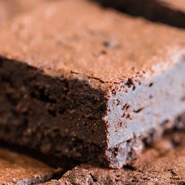 Brownies We pride ourselves on the dense richness of our brownies and use chocolates with a fermented bitter hint to counteract the sugar in the recipe.