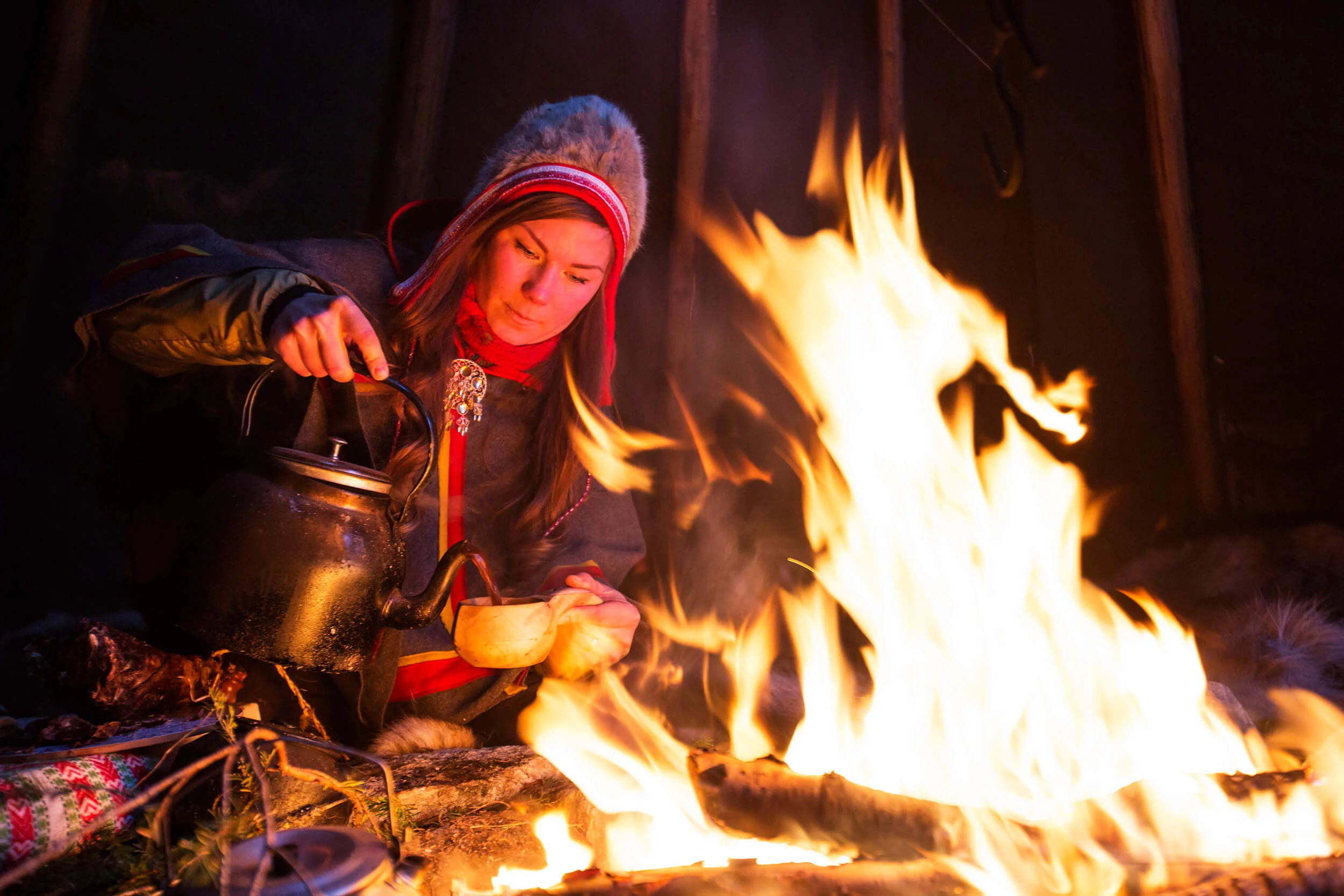In northern Sweden, many people drink what is called "kokkaffe." Here the Sami woman, Anna Kuhmunen, boils her coffee above the polar circle.