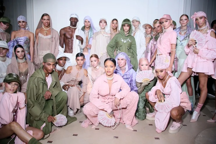 Rihanna backstage with models at Fenty x Puma Runway Show Photo from Getty Images