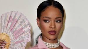 Rihanna poses with Fenty X Puma fan Photo from Getty Images