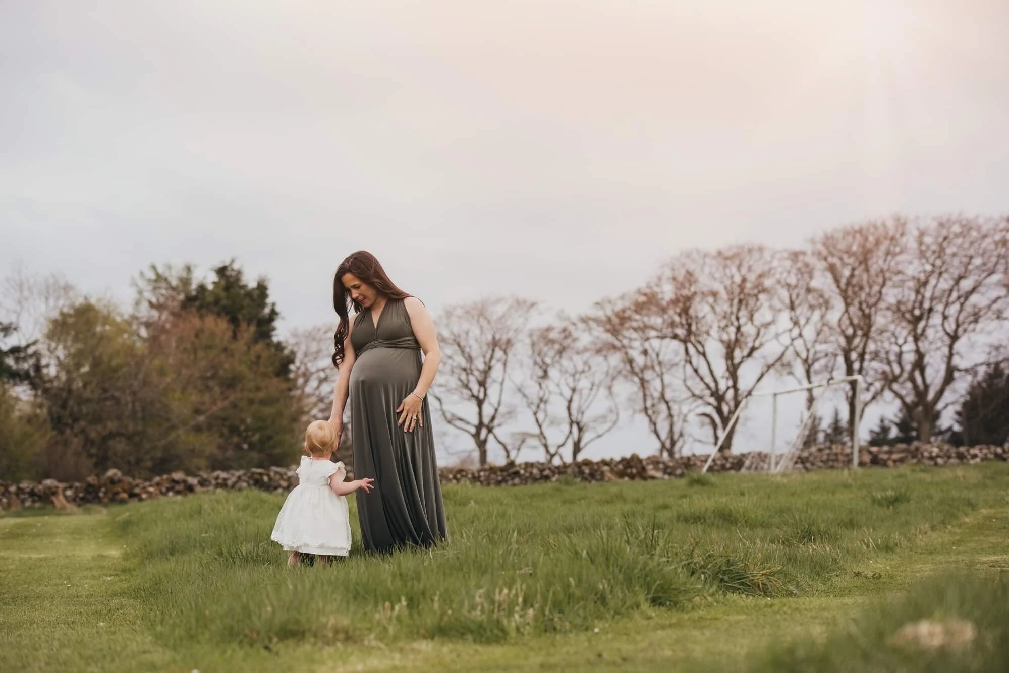 rsz_Pregnant woman with toddler in a white dress in a garden.jpg