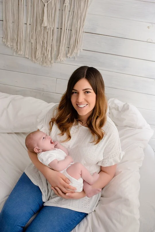 Mother with baby in her arms during a newborn photoshoot at Kingshill Studios