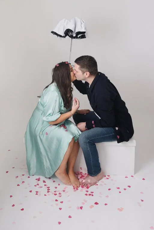 Couple kissing after an exciting gender reveal photoshoot