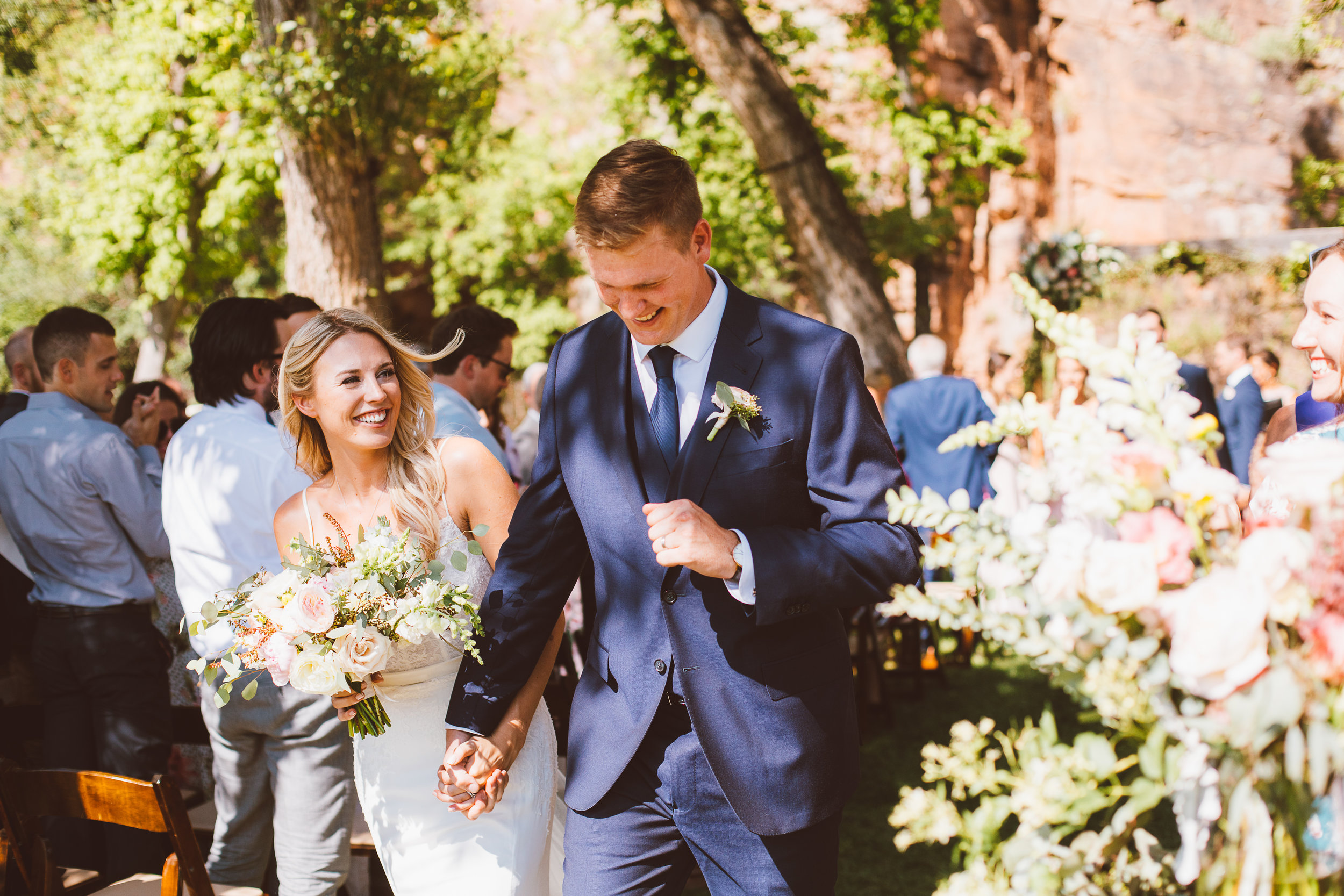 Bride and groom walking down aisle at ceremony