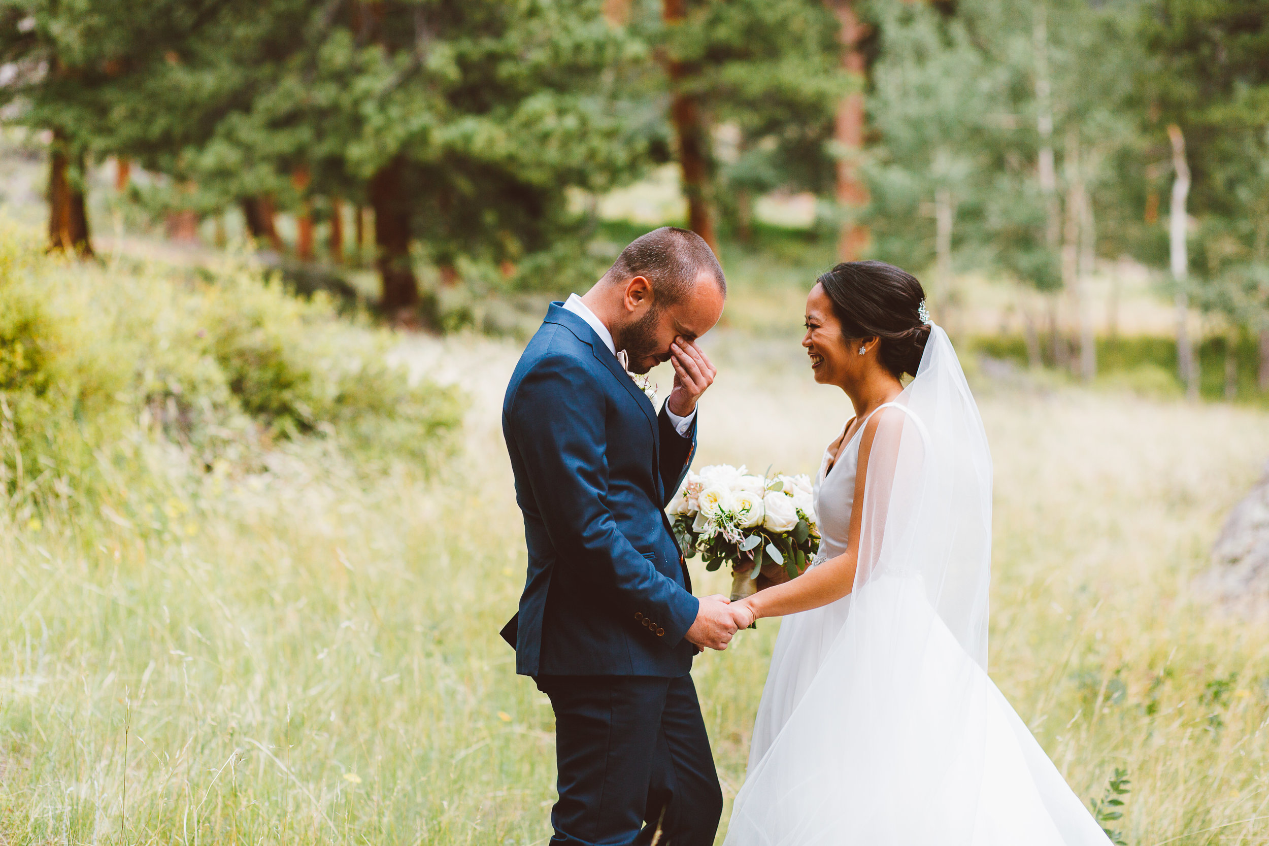 Groom crying during first look at wedding in Estes Park Colorado