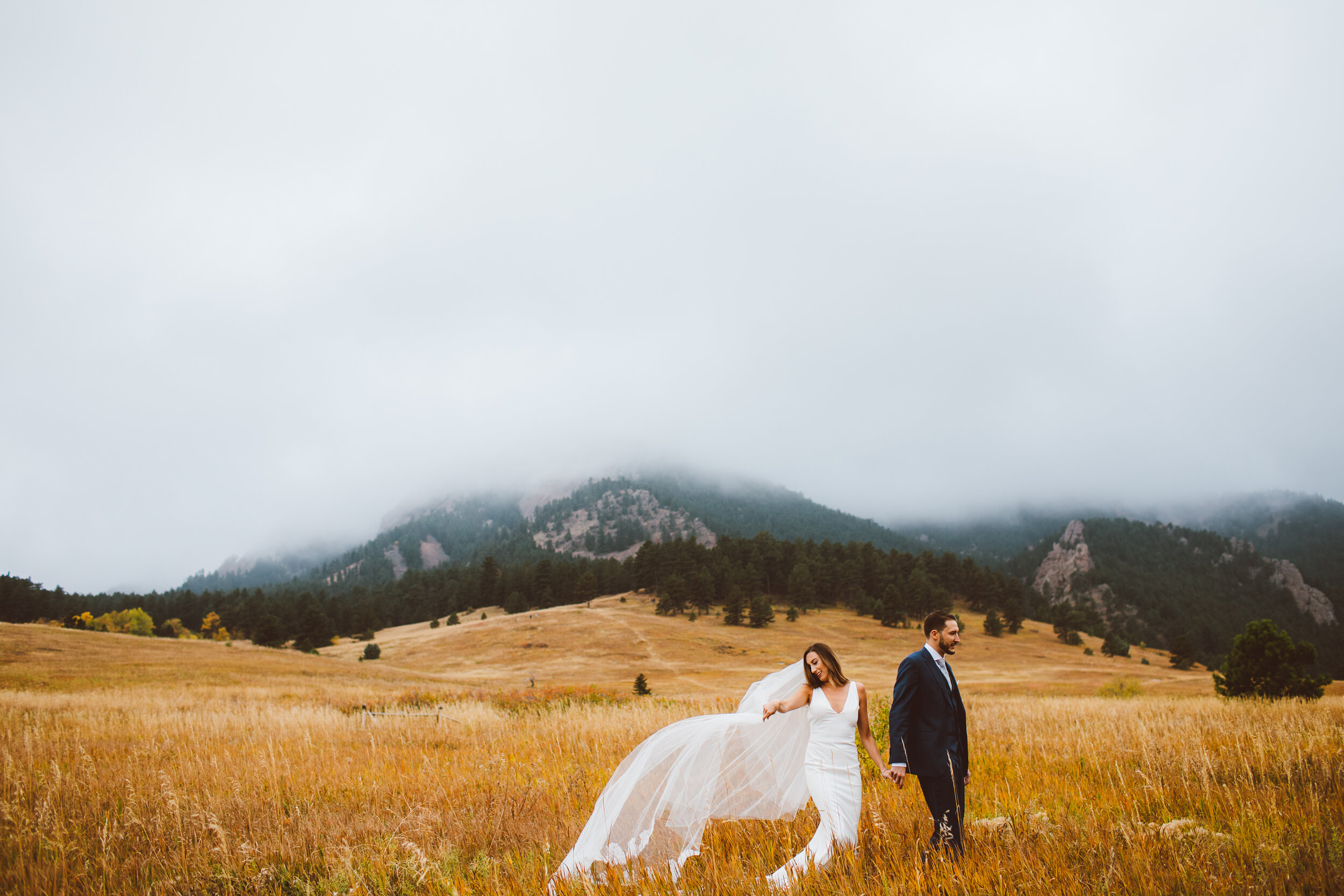 Bride and groom walking at Chautauqua park in Boulder, Colorado