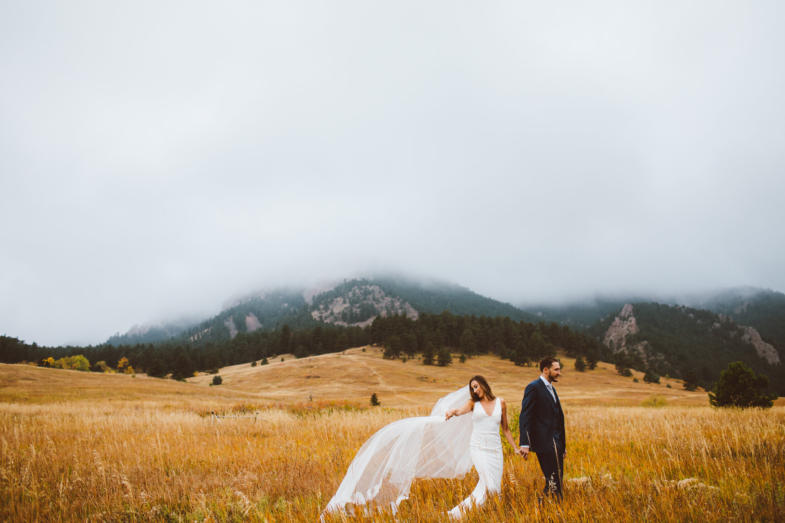 Bride and groom walking at Chautauqua park in Boulder, Colorado