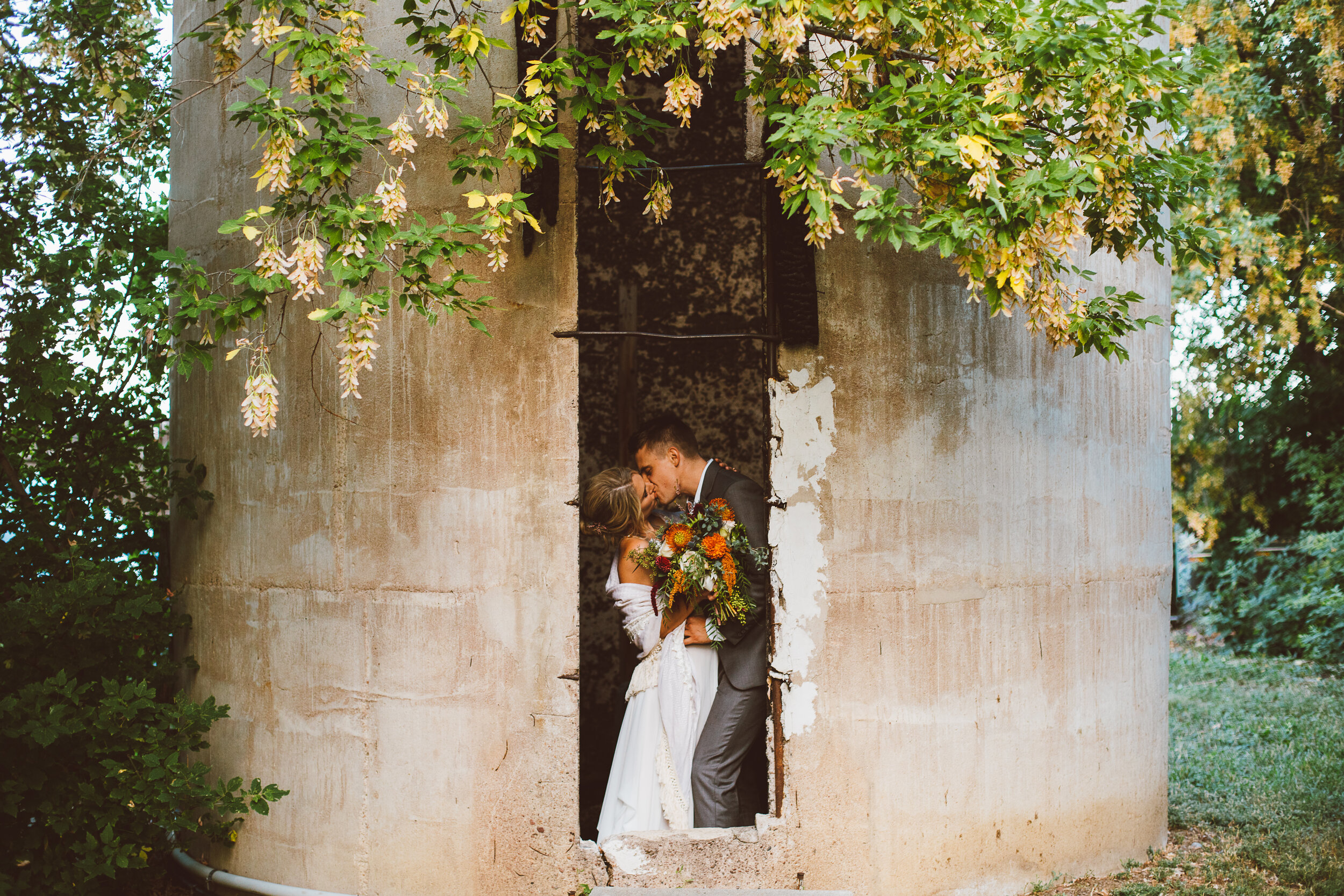 Bride and groom kissing inside a silo in Boulder Colorado