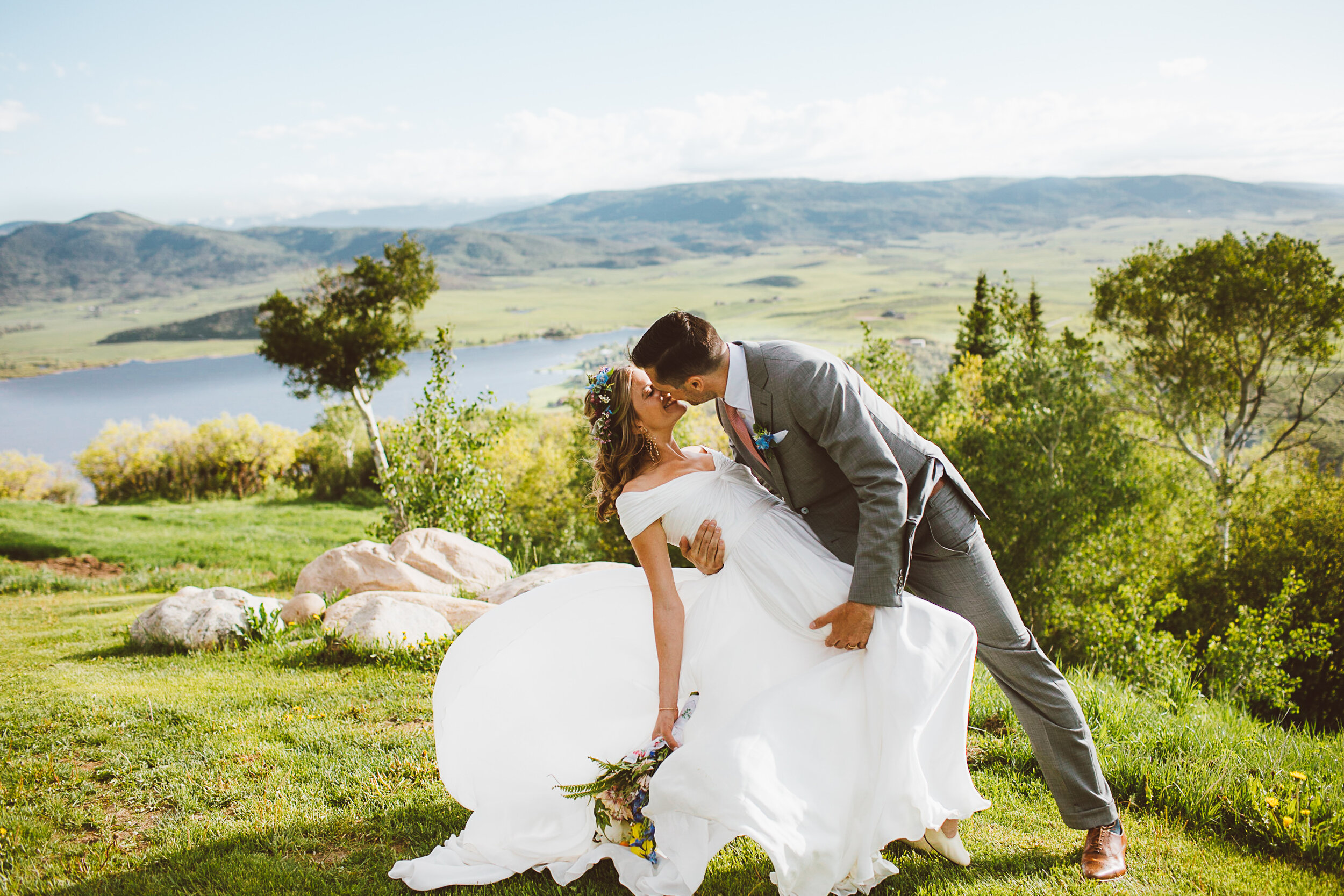 Bride and groom kissing with dress flowing in Steamboat Springs Colorado