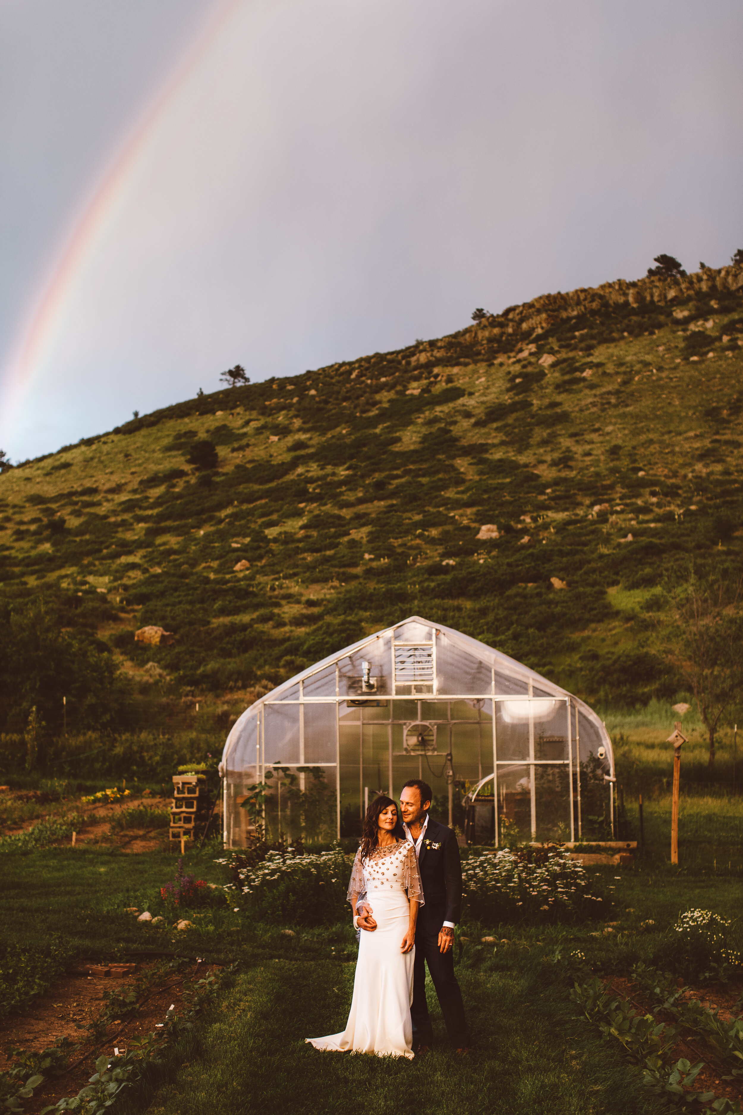 wedding couple with a rainbow at The Farmette in Lyons, Colorado