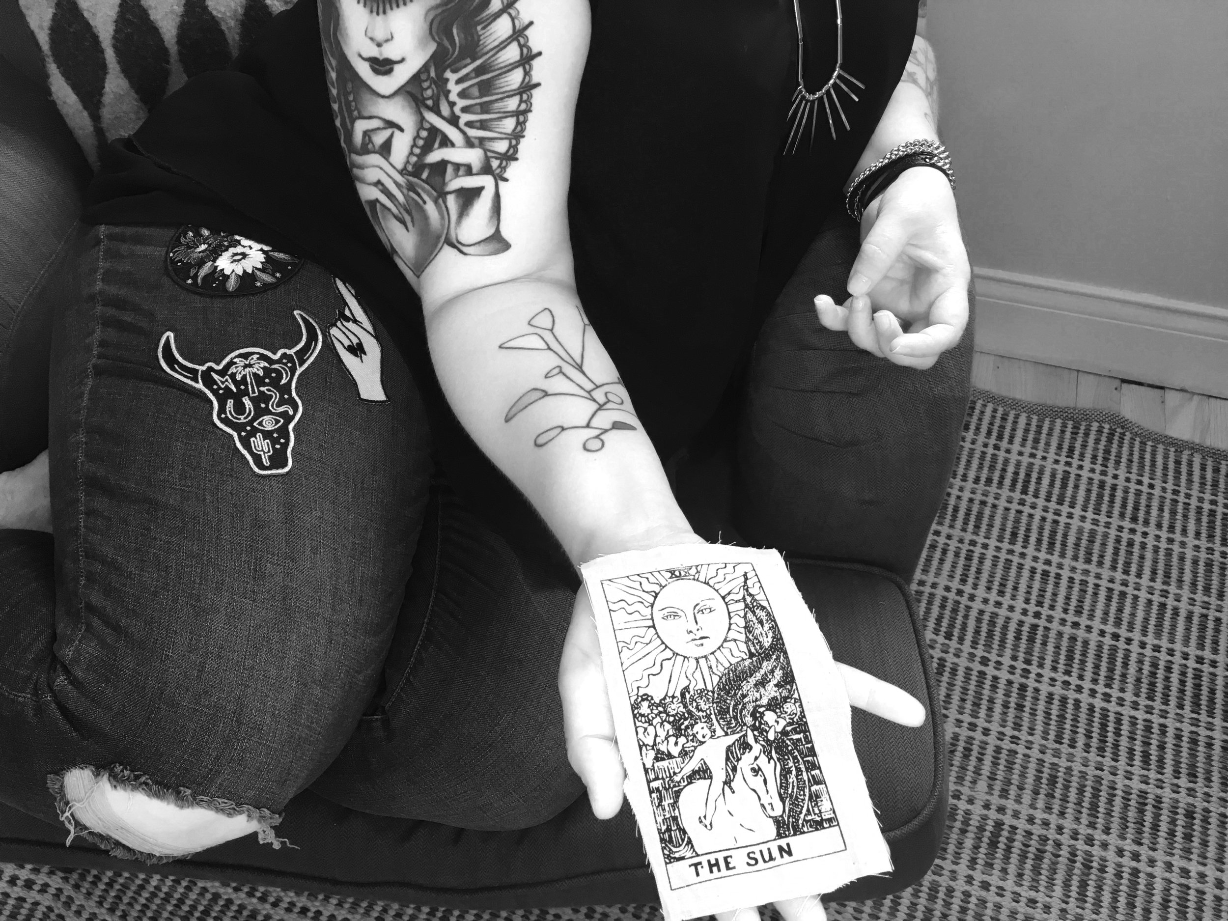 Amanda Stilwell holds a canvas patch of "The Sun," one of the tarot cards designed by Pamela Colman Smith in 1909.