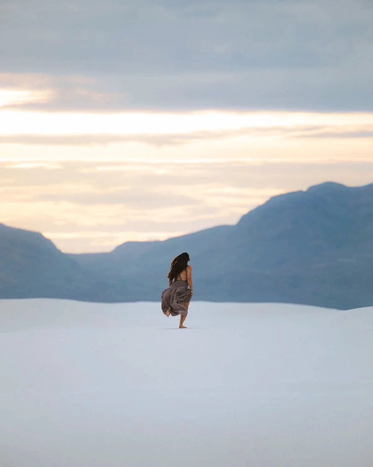 white-sands-new-mexico-landscape-mountains-national-park-girl-running-into-sunset.jpg