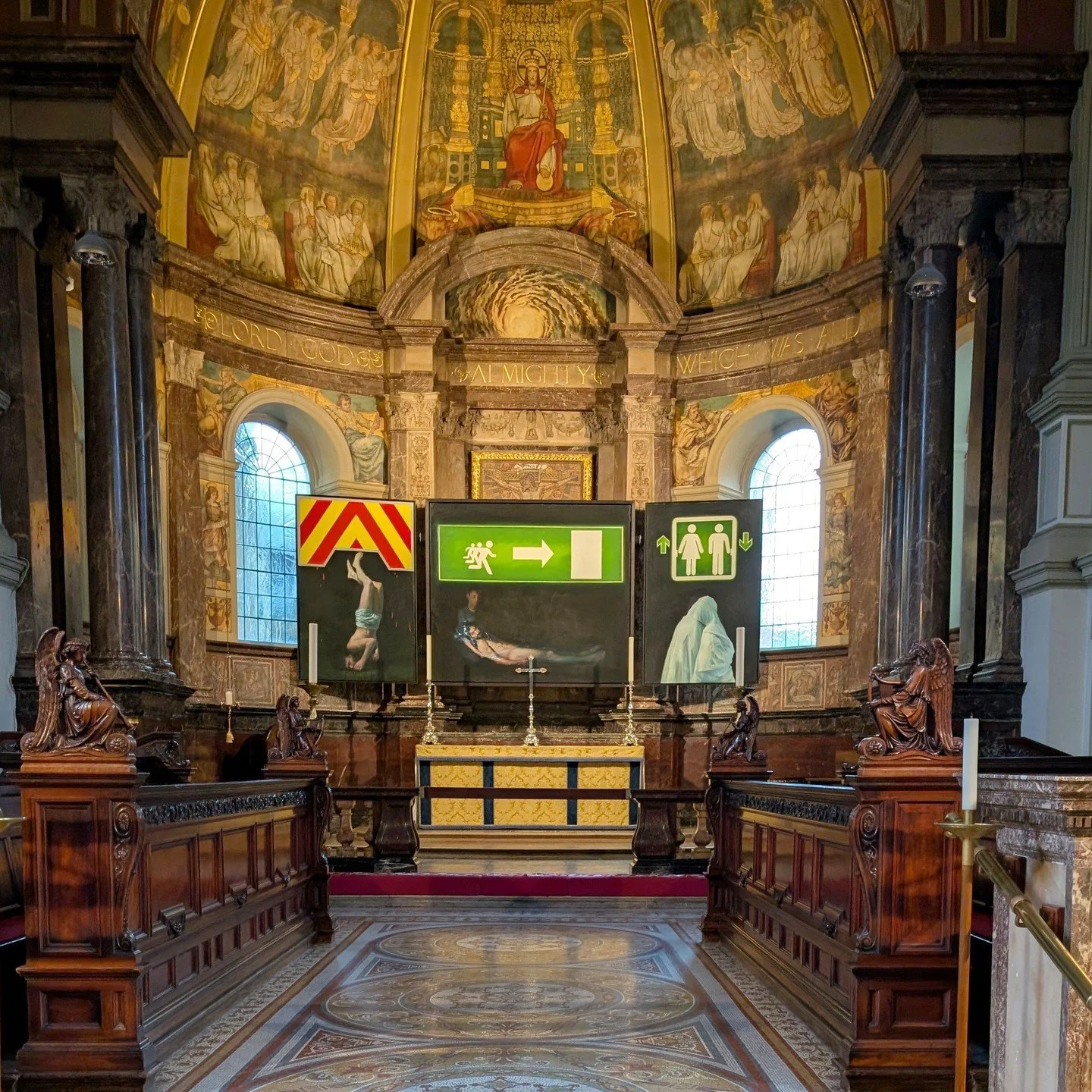 How do you give the traditional church triptych altarpiece a contemporary twist? Paul Benney has painted the traditional religious motifs of the descent from the cross, the entombment of Christ, and mourning figures and placed them alongside illumina