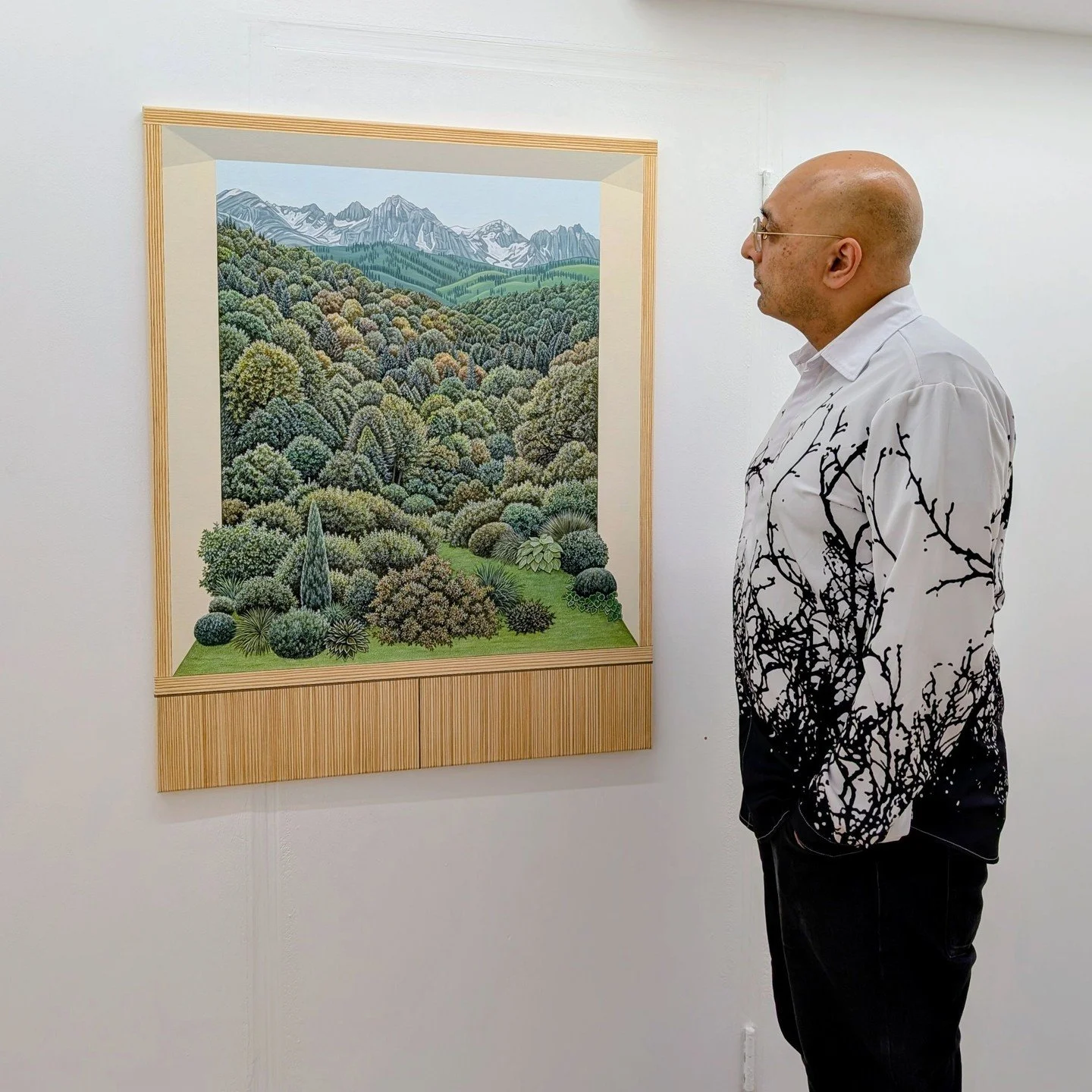 The natural world meets the straight lines of the man-made as animals are placed throughout a hedge maze, and cacti pop up through and around a window frame. Is this nature reclaiming our world, imposing our structures on nature, or a bit of both? Th