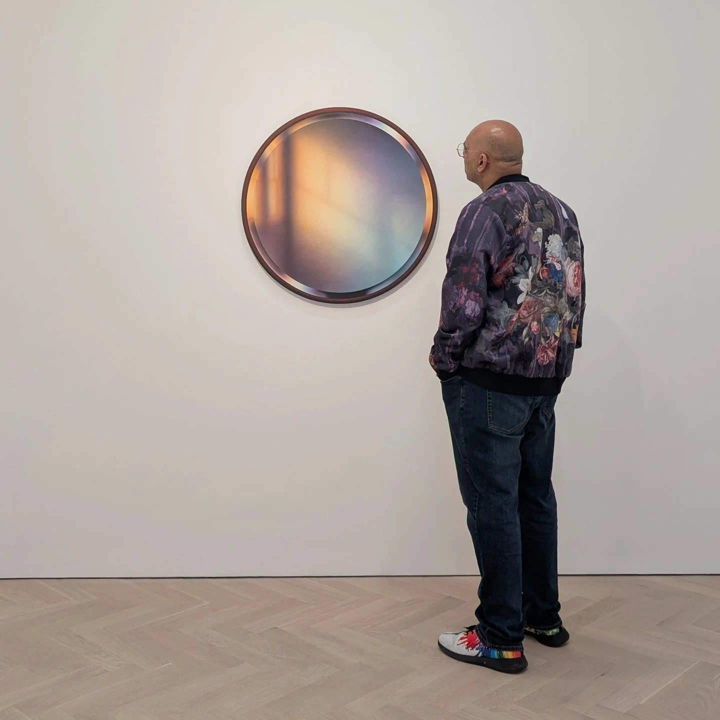 These aren&rsquo;t mirrors, and that&rsquo;s not light reflecting off of them. These meticulous paintings make it seem as if they are mirrors reflecting sunlight, but it&rsquo;s all an illusion. The works have been spaced out across the galleries so 