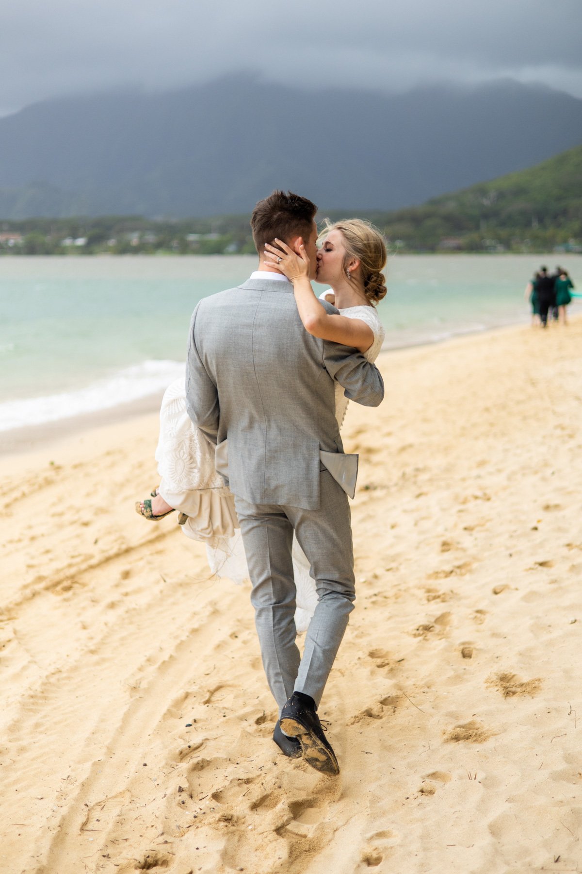 romantic bride and groom kiss on the beach
