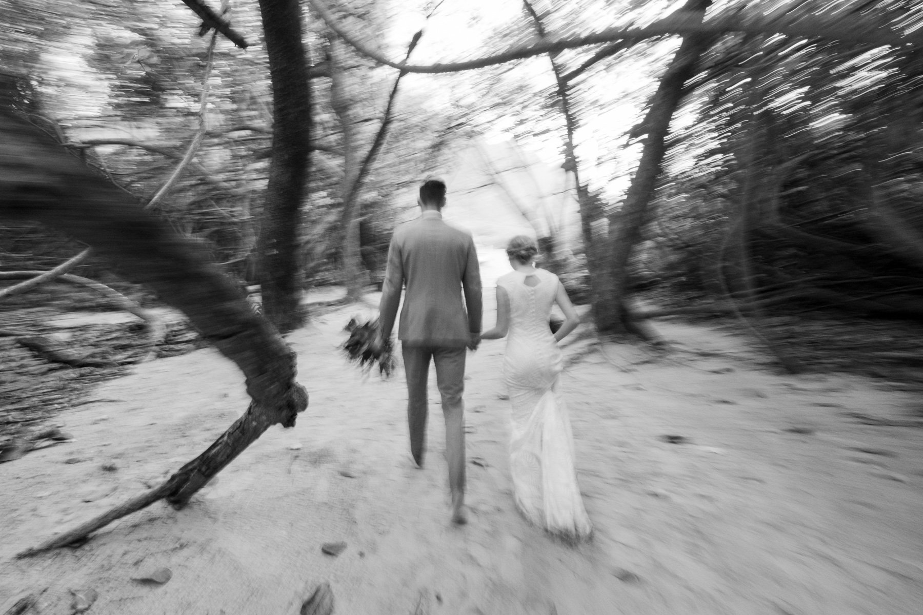 intentional blur image of bride and groom walking