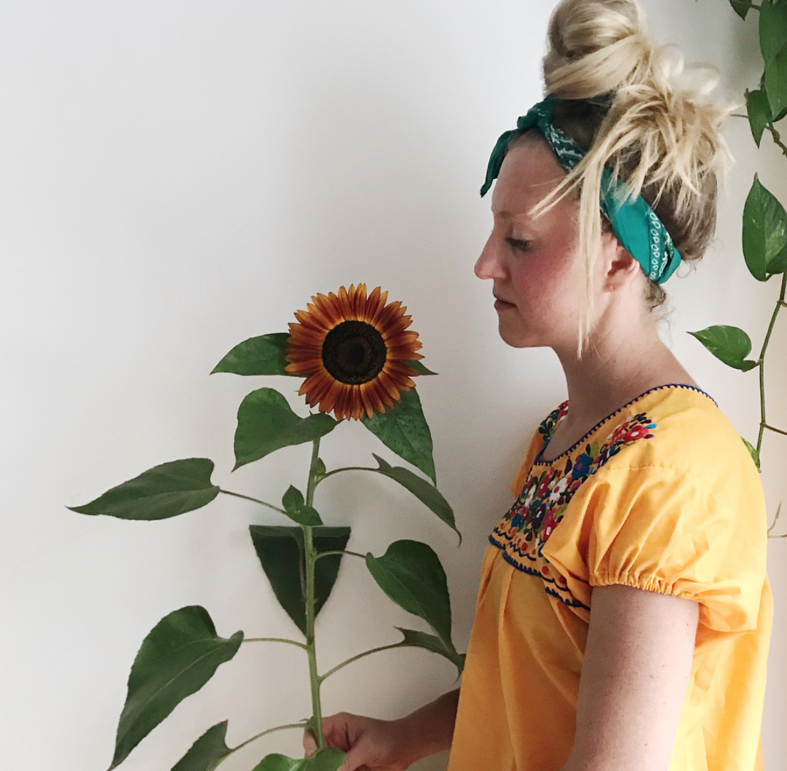 Me, with a sunflower I grew from my fire escape garden
