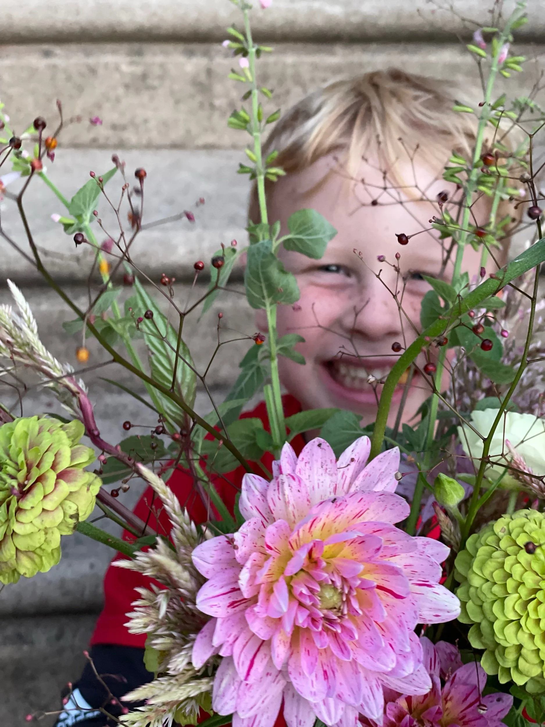 Jack with flowers in front of face.jpeg