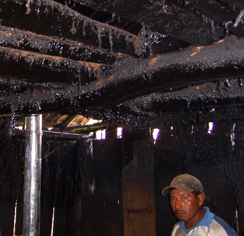 The constant smoke coats the ceiling of the hut, and the villagers' lungs.
