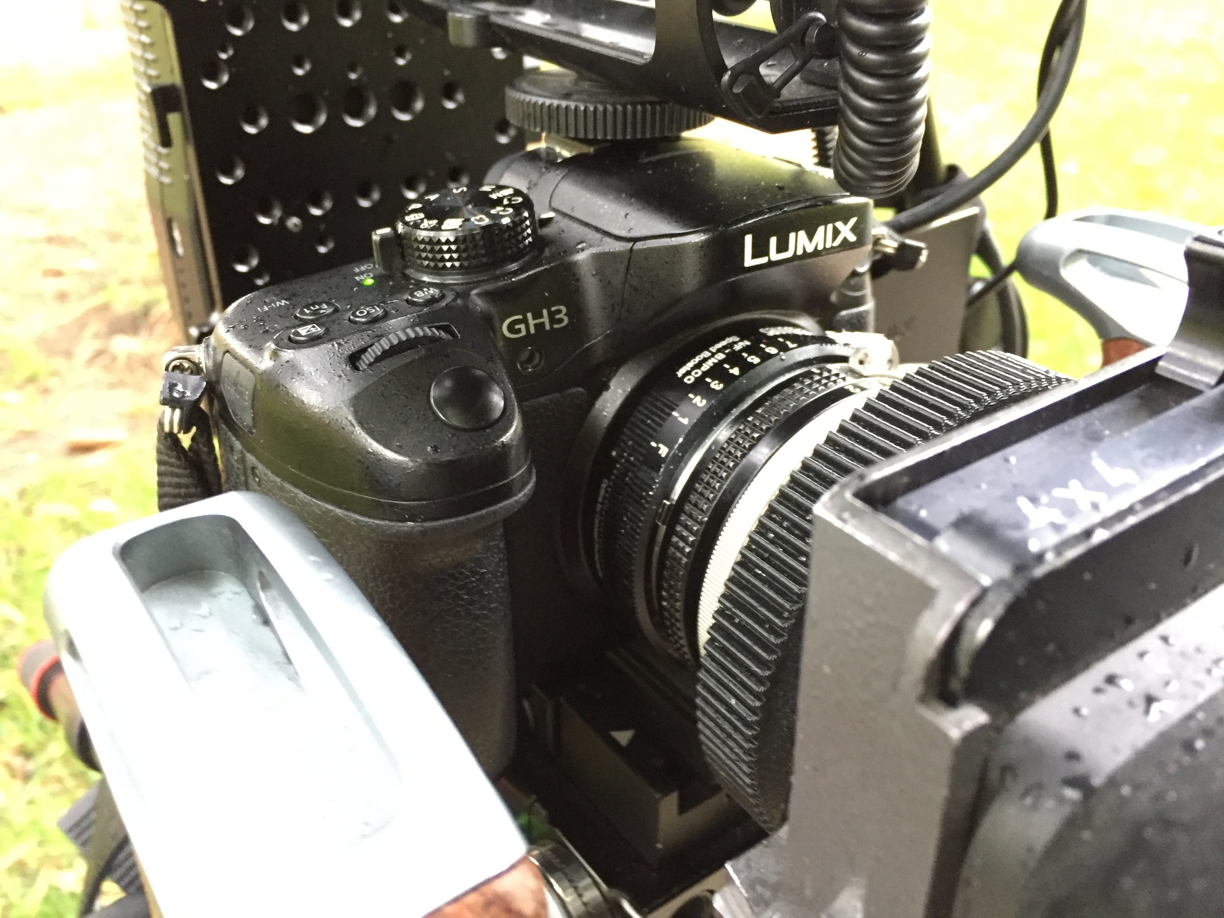 A shot of the camera rig mid-production in the rain. We shot on the Panasonic GH3 and Nikon D7000. The lens was an old Nikkor 24 1.4mm prime + speed booster. In addition, an Arri matte box.