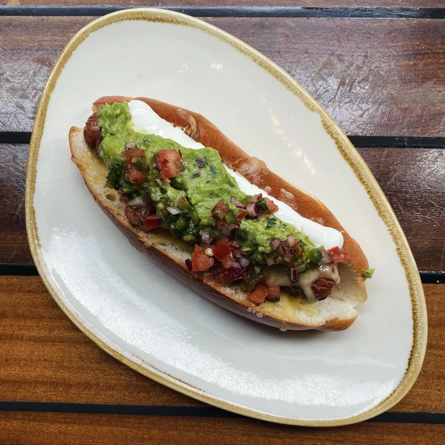 Let&rsquo;s give em something to TACObout&hellip; Is a hot dog a taco? This wacky weiner continues our great debate series, daring to ask the question, What Even Is A Sandwich?? The Taco Dog features guac, pico, sour cream, and melted queso. Only ava