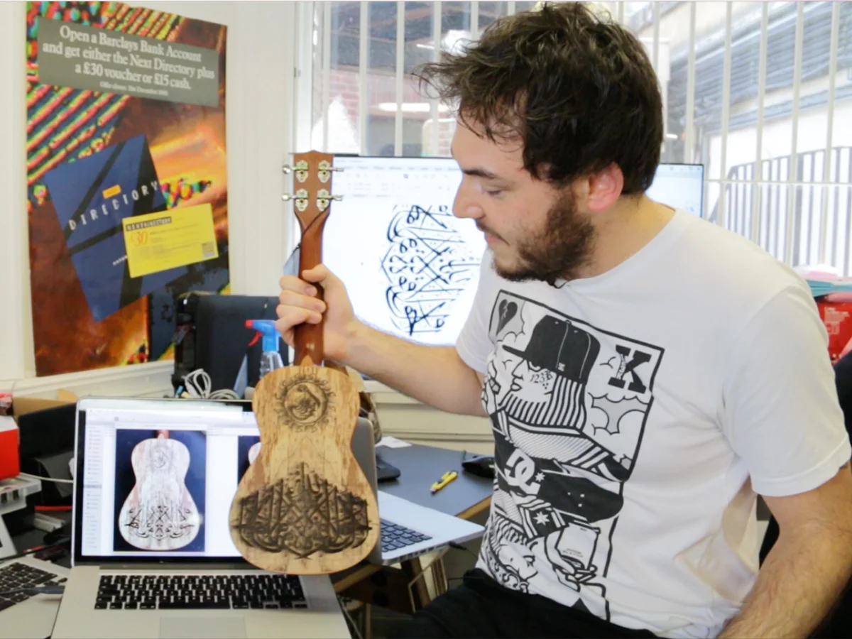 tom lamont with arabic etched ukelele for Tabi Stew. Made by Burntaxe brighton