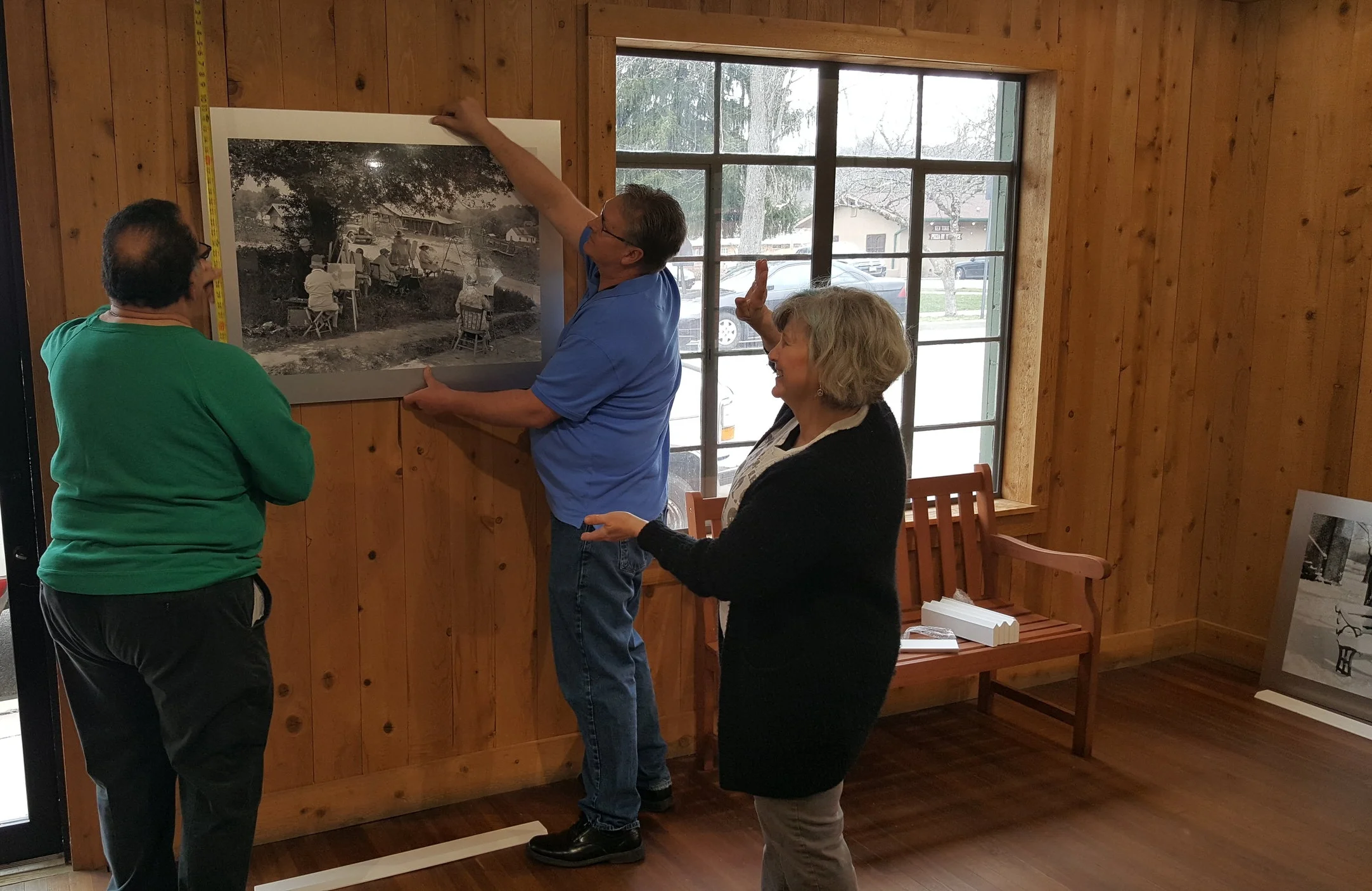 hanging hohenberger prints at the village green restrooms