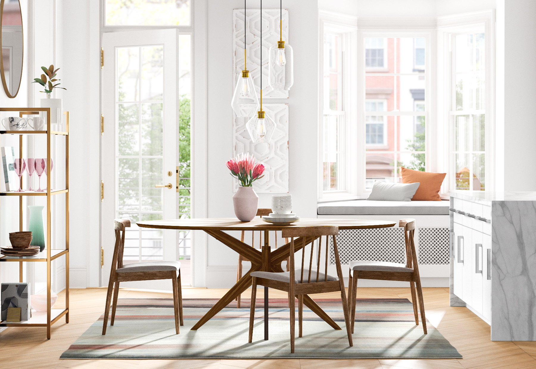 Bright dining area with a wooden table and four chairs. A pink vase with pink flowers, stacked white plates, and bowls are on the table. Large window seating with orange and white cushions is in the background. There are hanging pendant lights above