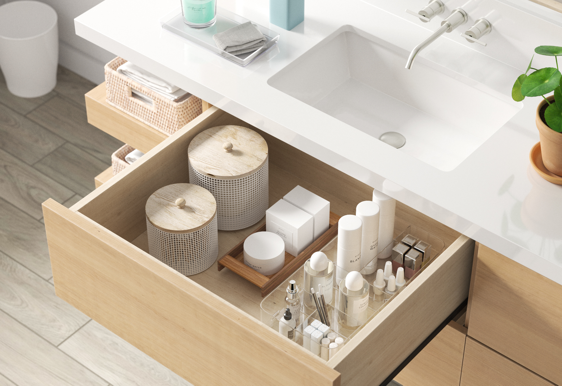 Open bathroom drawer with skincare and cosmetic products, two white containers with wooden lids, and organized toiletries on a wooden tray.