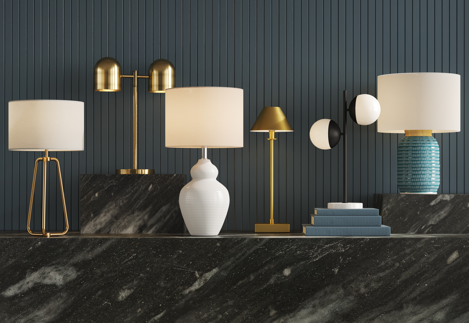 Table display of various table lamps and decorative objects against a dark blue wooden wall.