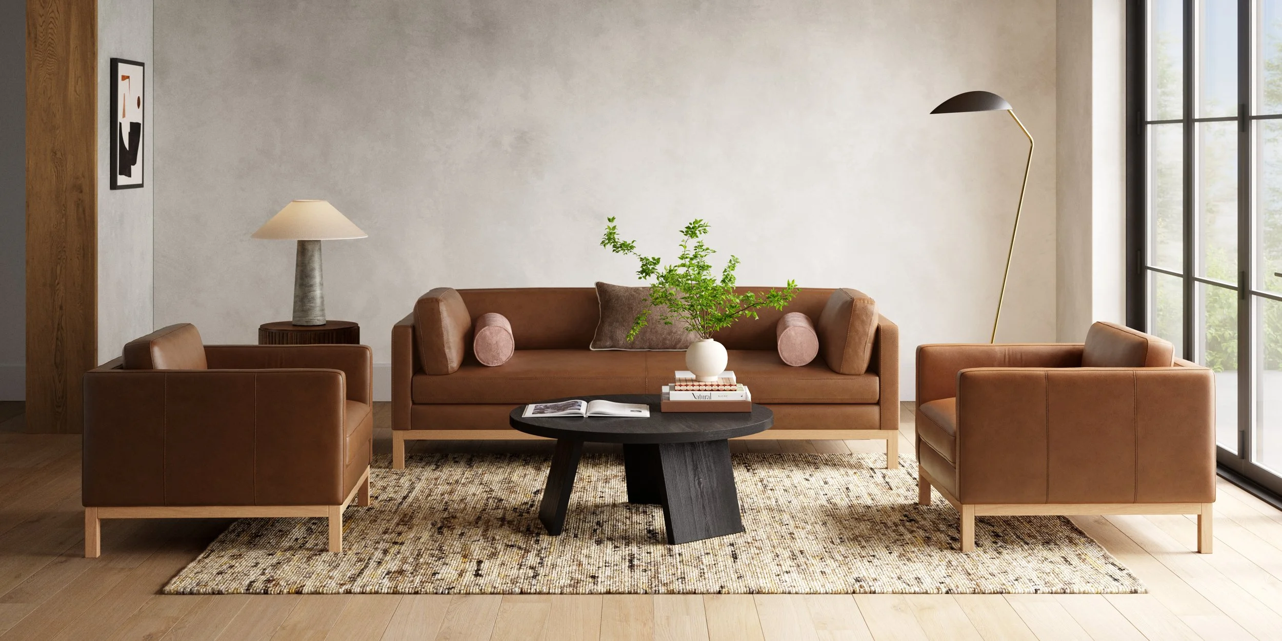 Living room with three brown leather sofas, a black coffee table, a patterned rug, a side table with a lamp, a potted plant, and large windows.