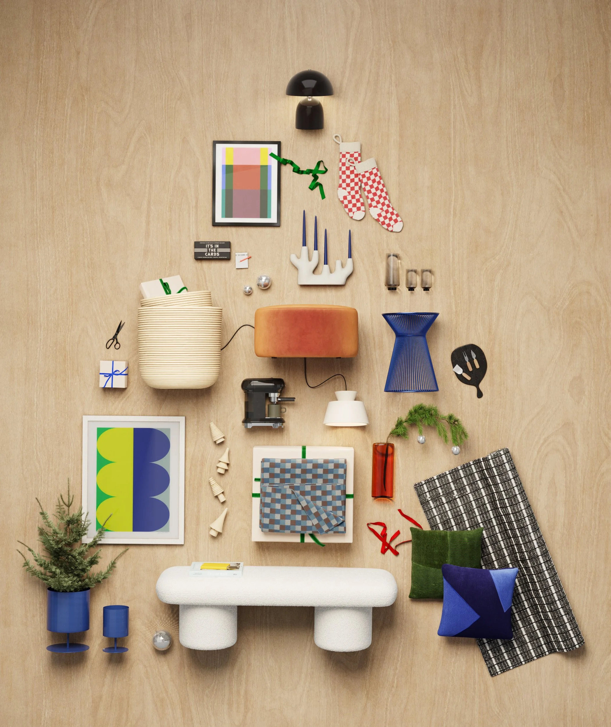 A flat lay of various household decor and decor items arranged on a wooden floor, including plants, artwork, a bench, cushions, lamps, and miscellaneous decorative objects.