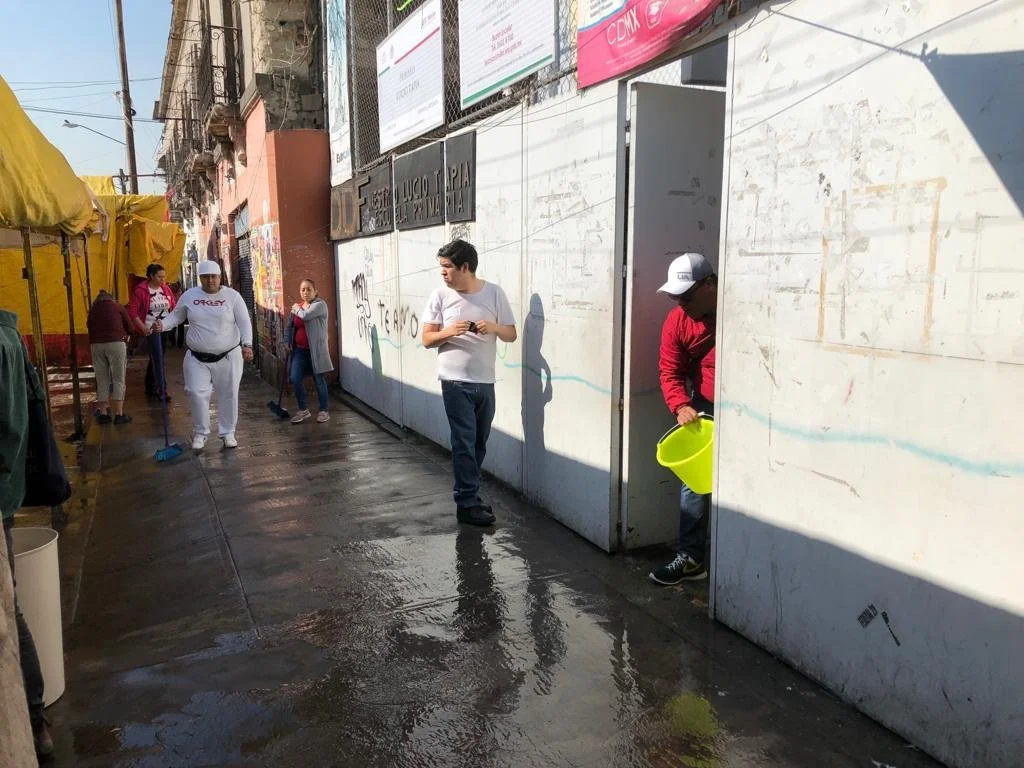 Cleaning the street outside an elementary school with students' parents