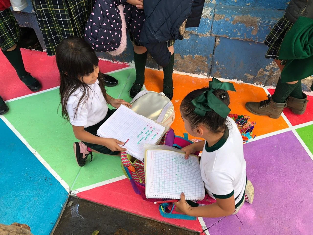 Students doing their homework on a painted street