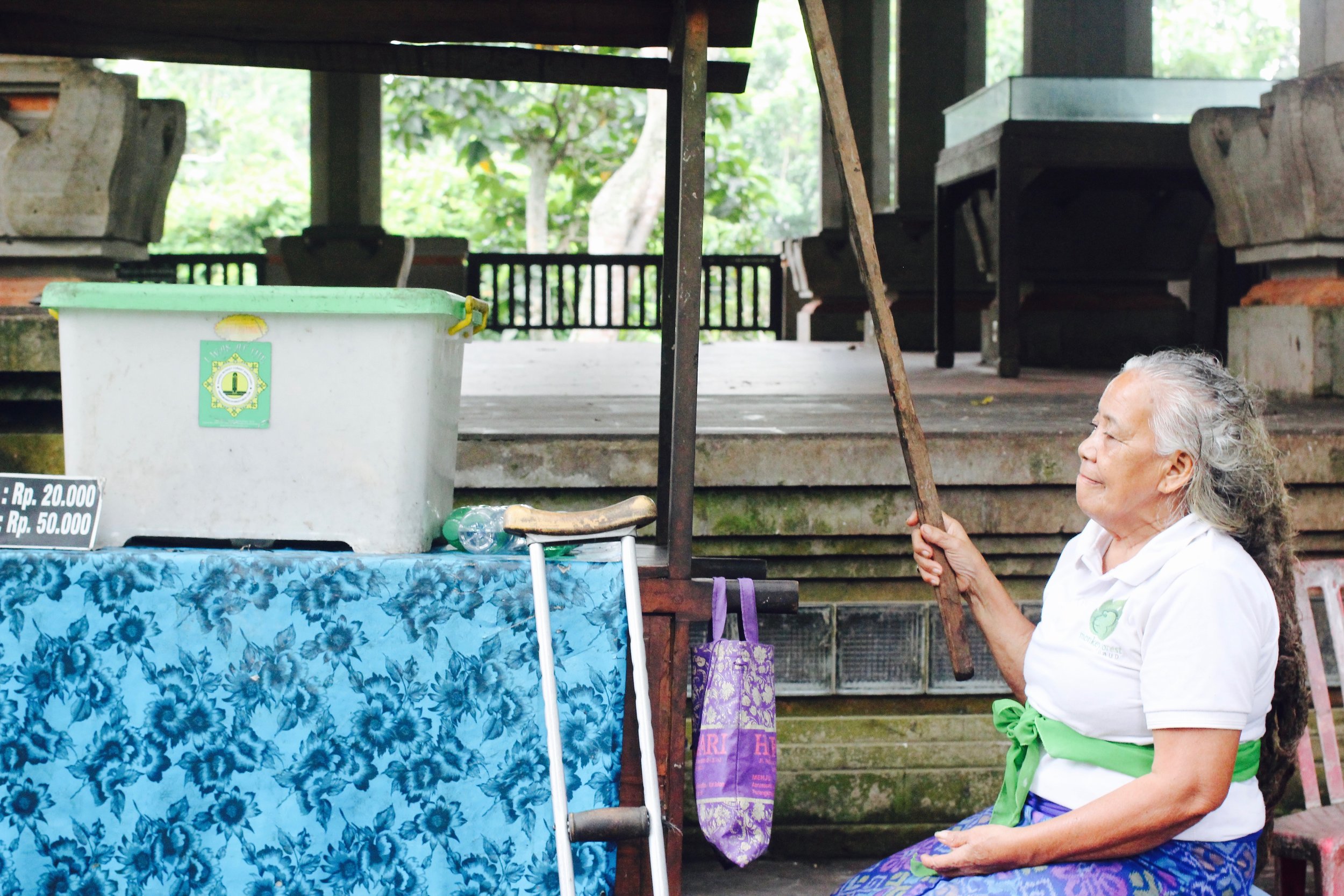 Balinese woman keeps law & order with her monkey stick