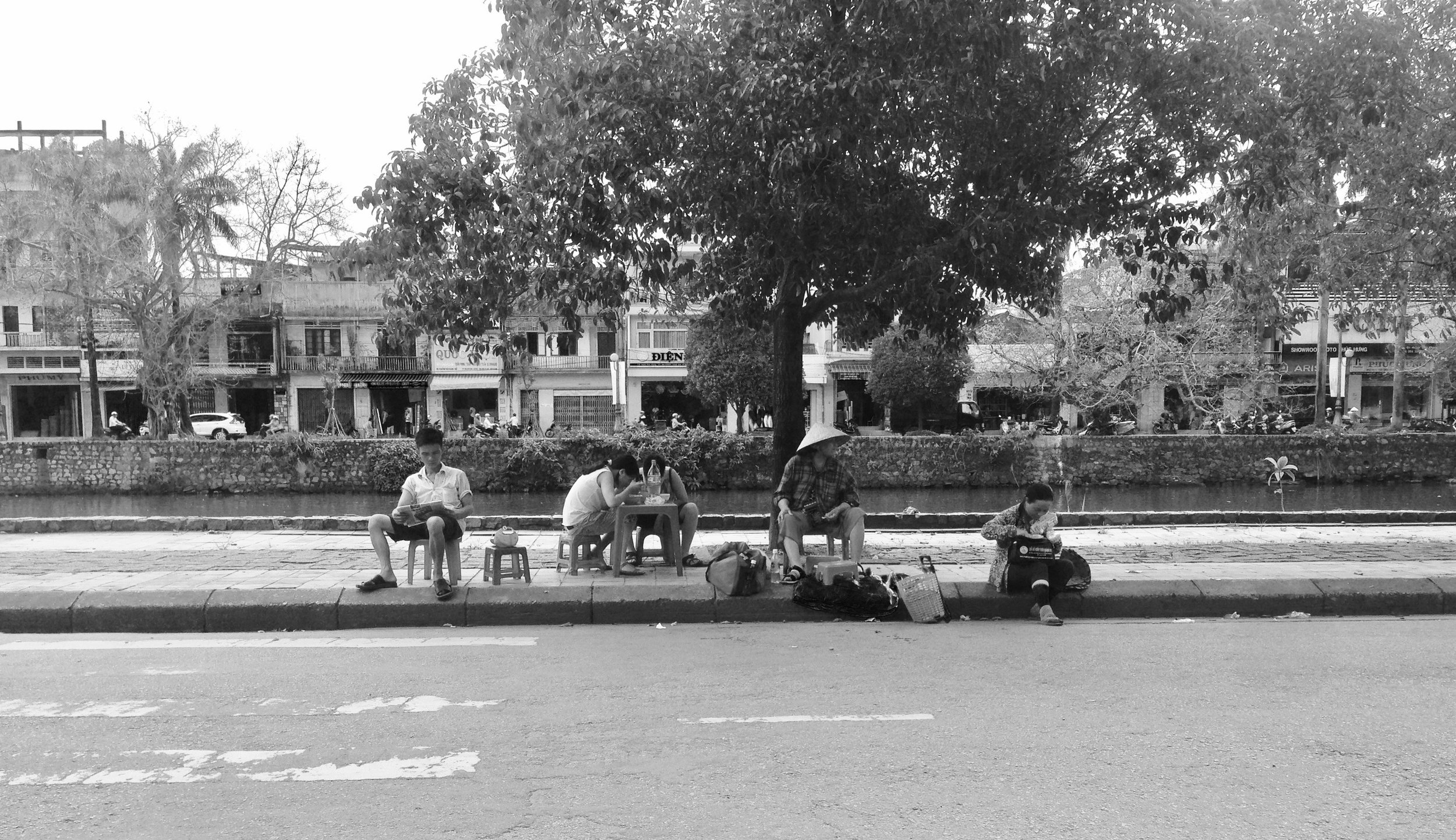 Typical sidewalk action in Hue - little chairs set up for newspaper reading, snacking and traffic watching