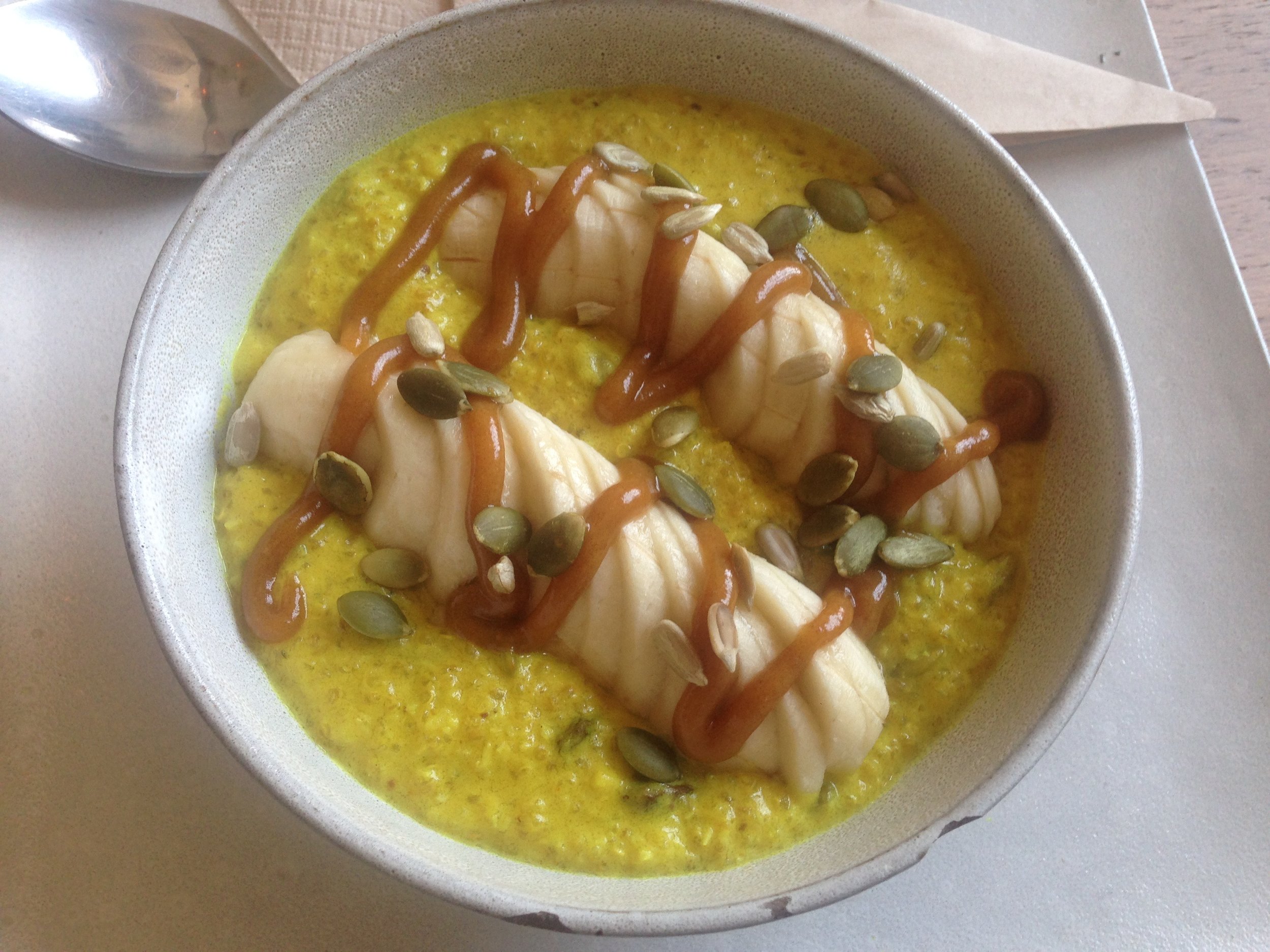 Banana quinoa porridge with turmeric and salted caramel drizzle