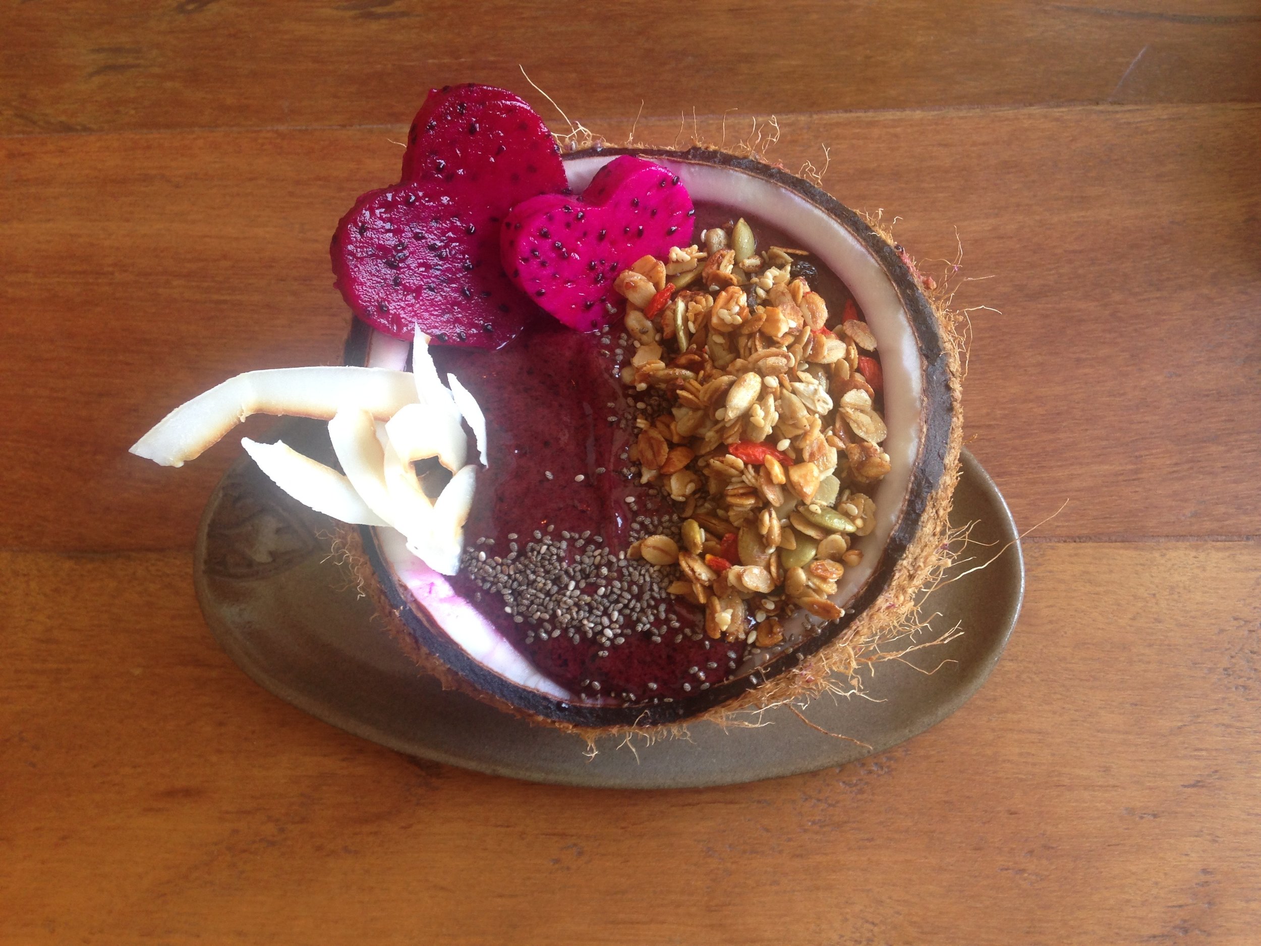 Granola and coconut shreds soaked in an acai bowl 