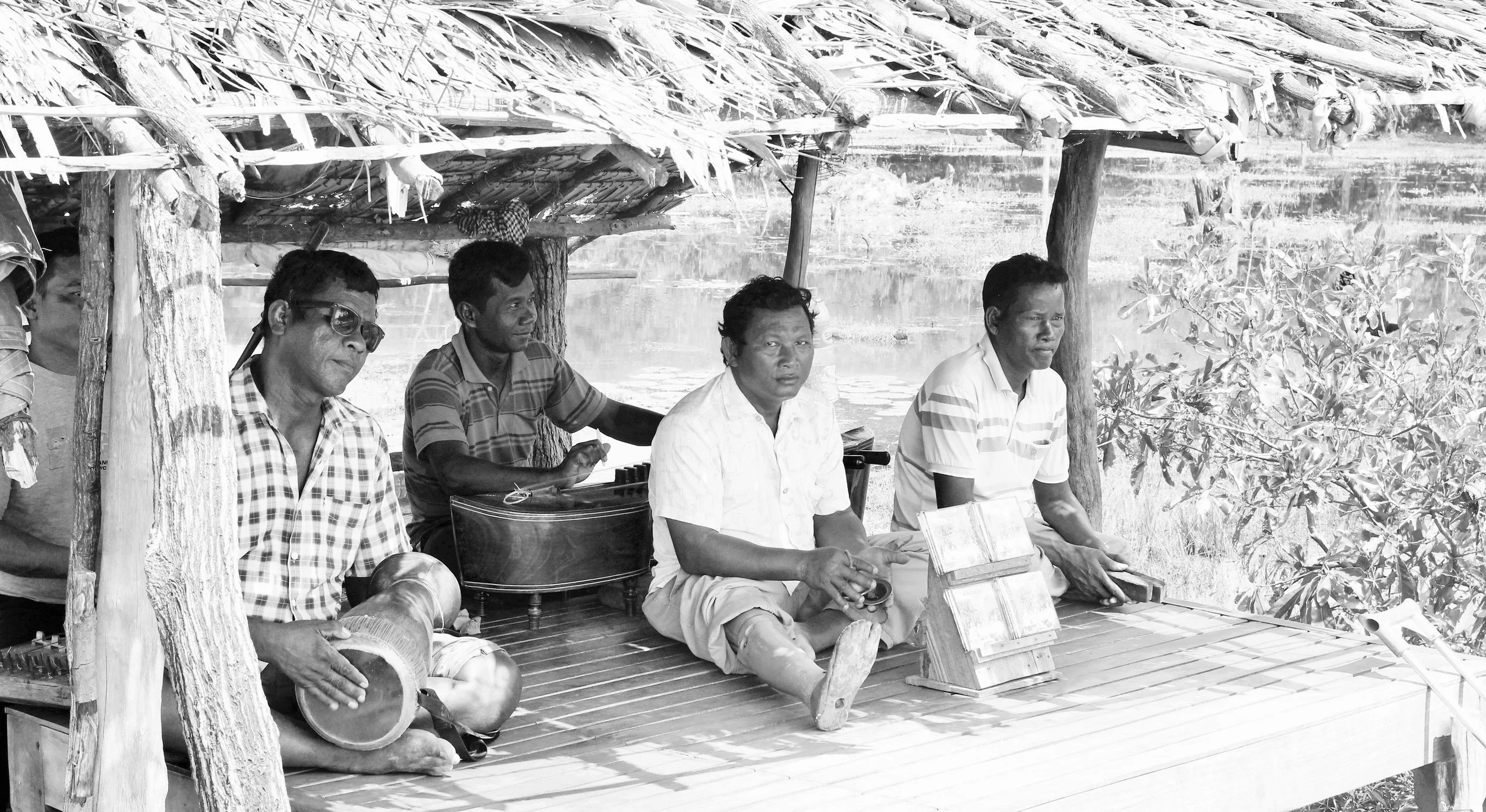 Khmer musicians playing inside temple grounds 