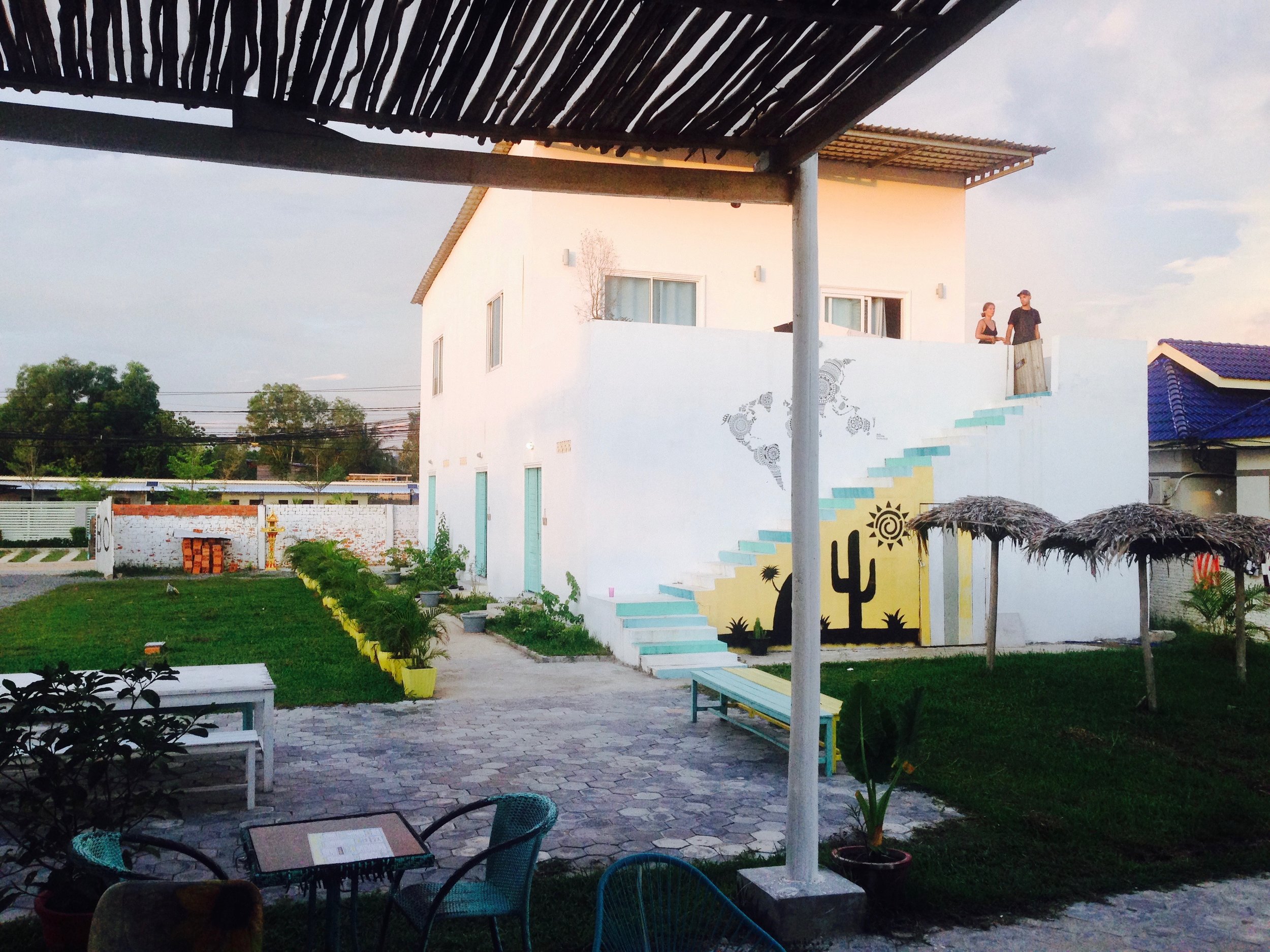 View from the cafe looking onto the hostel building - owners Emilie and Josef walking down from their bedroom upstairs 