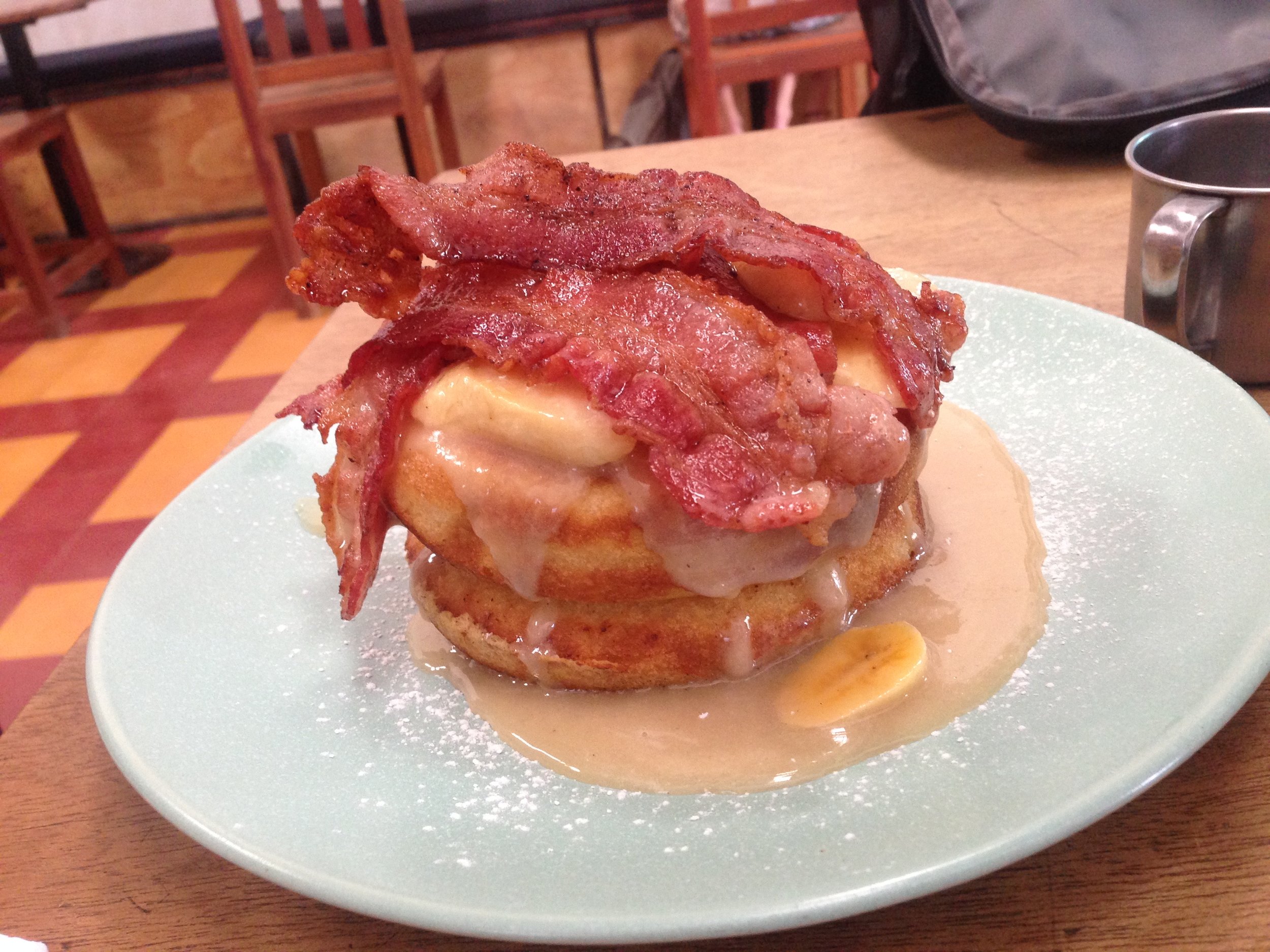 Double stacked pancakes coated in salted caramel syrup, topped with caramelized bananas and BACON. Basically, eat, die, and go to heaven.