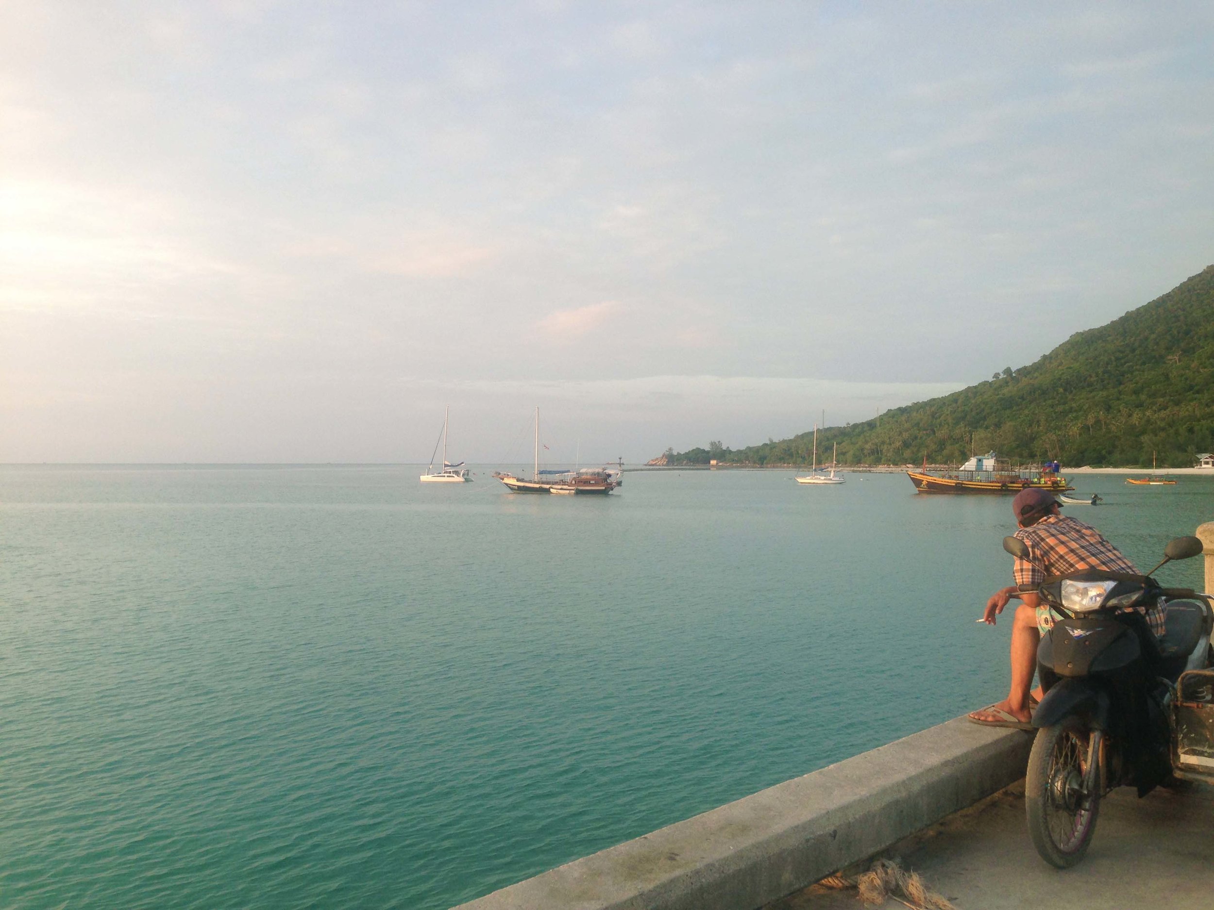 Sunset one at Chaloklum pier - a ritual shared by local Thais and travelers alike.