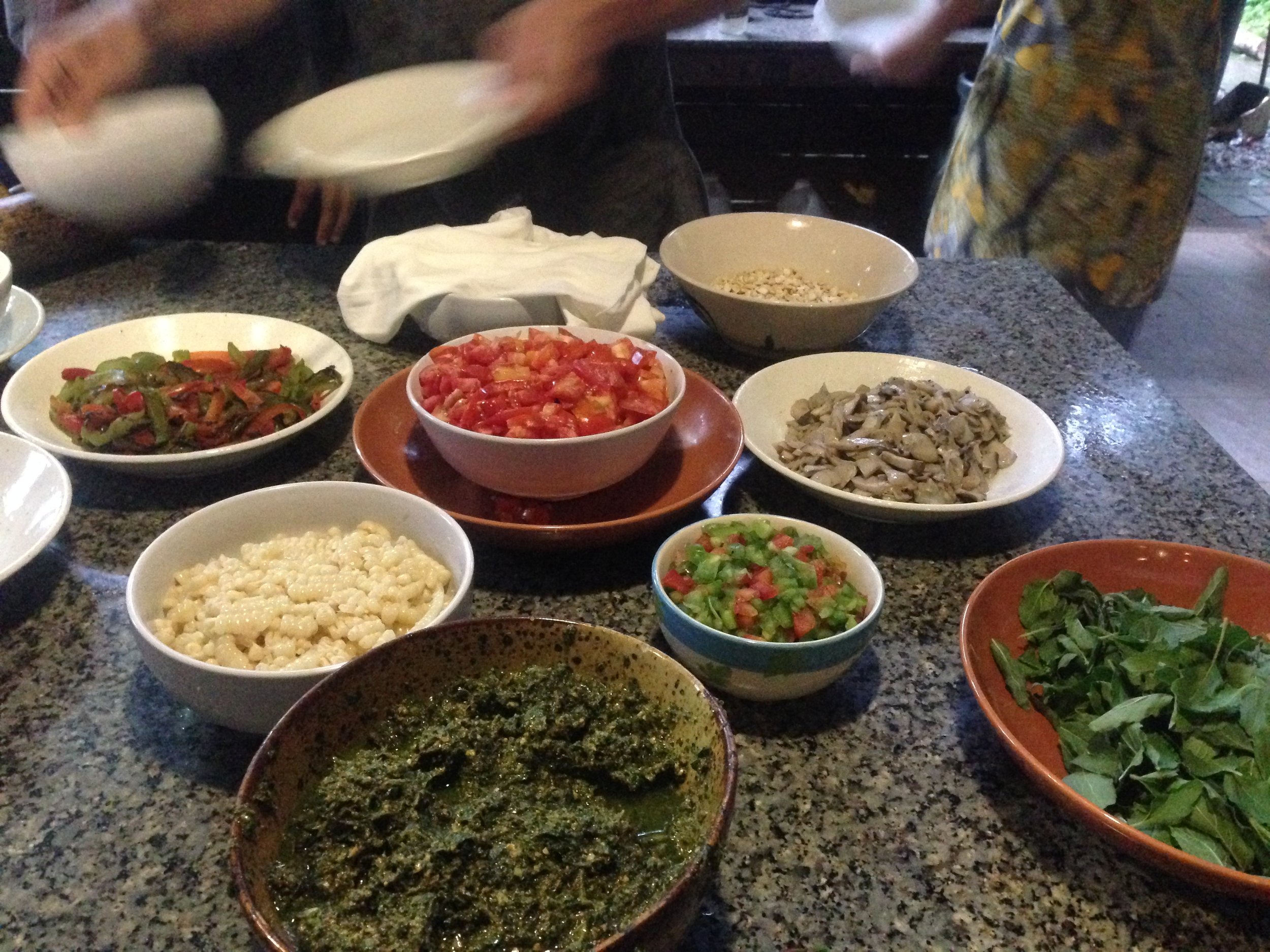 Panya pizza toppings, fresh from the farm and village market. On pizza nights, ALL hands are on deck. There are never too many cooks in a kitchen at Panya :)