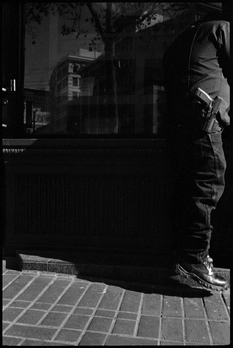 #0470_05A - Man With Gun, Market Street. San Francisco, CA. October of 2016.