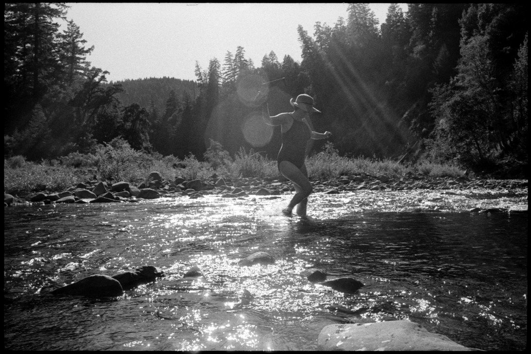 black and white photograph of a woman in the eel river in mendocino county northern california